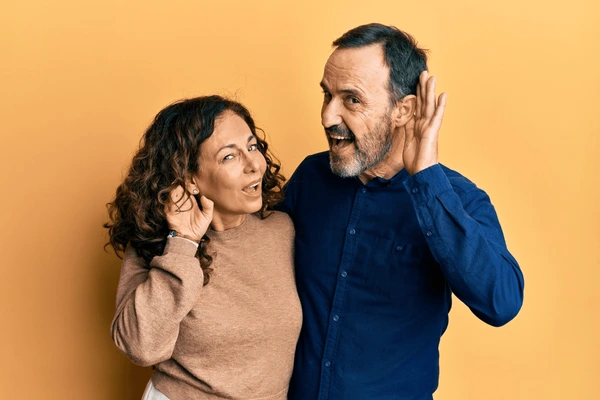 Couple wearing hearing aids together